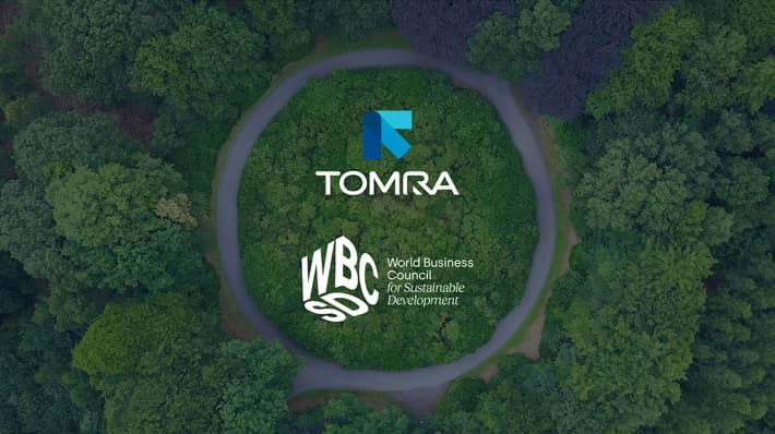 TOMRA and WBCSD logos against an overhead view of trees