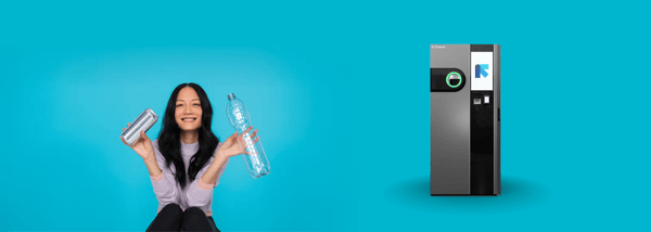 Girl holding two bottles in front of a TOMRA B5 Mix